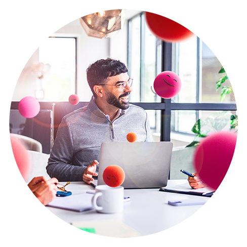 Mann am Laptop um ihn herum lachende Emojis